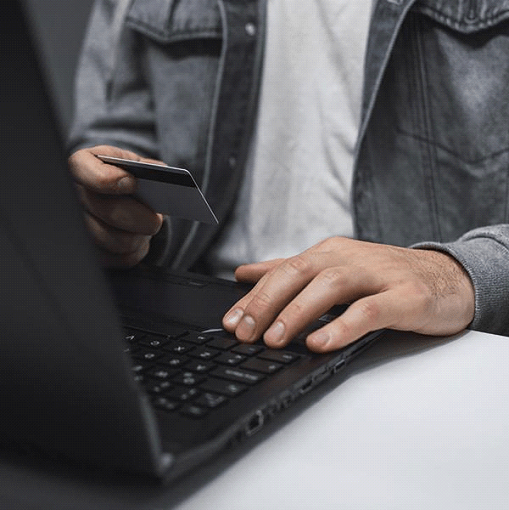 man adding information from card to computer